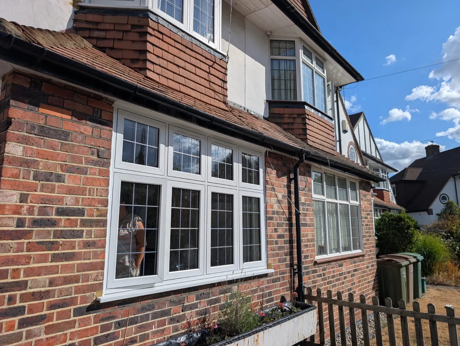 Four-light casement across the brick frontage, with matching leaded top lights