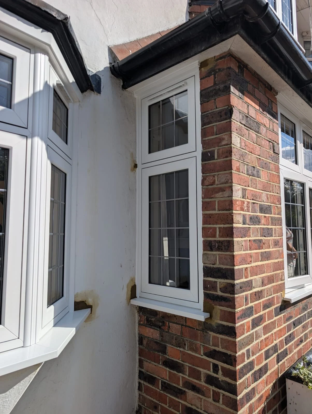 Corner window between the bay and the brickwork, fitted tight to the original cill line