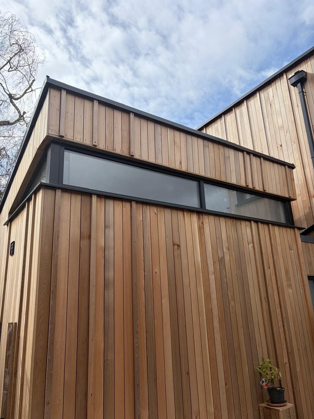 Black aluminium windows on contemporary timber-clad new build, Surrey